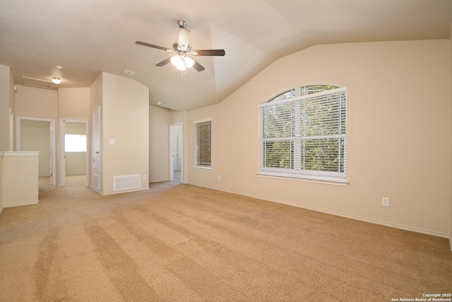 unfurnished bedroom featuring visible vents, vaulted ceiling, light carpet, and baseboards