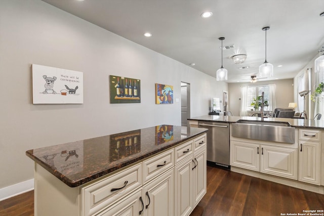 kitchen with recessed lighting, dark wood-type flooring, a sink, visible vents, and dishwasher