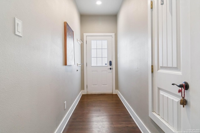 entryway with dark wood finished floors and baseboards