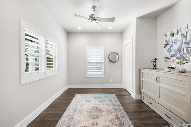 interior space featuring plenty of natural light, dark wood finished floors, and baseboards