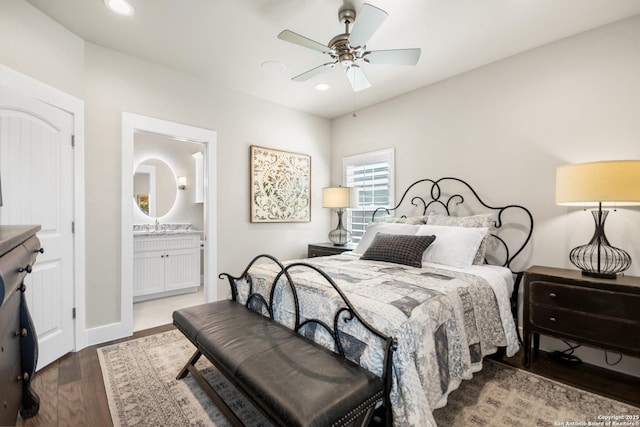 bedroom with recessed lighting, a ceiling fan, connected bathroom, a sink, and wood finished floors