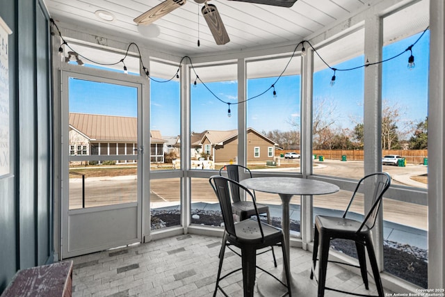 sunroom / solarium featuring ceiling fan