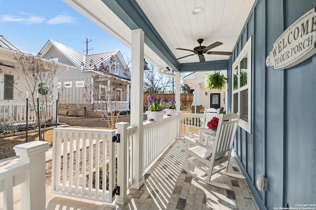 view of patio featuring covered porch, fence, and a ceiling fan