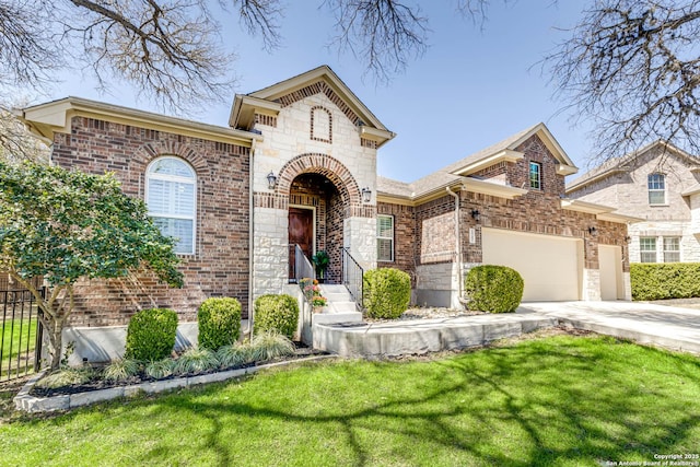 view of front of house with brick siding, concrete driveway, a front yard, and fence