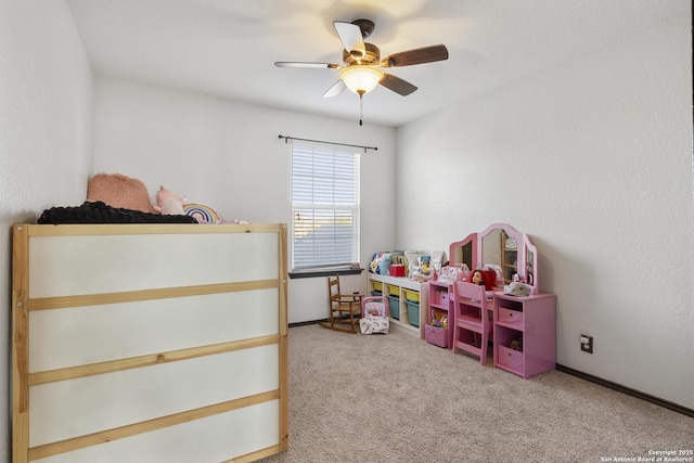 carpeted bedroom with ceiling fan and baseboards