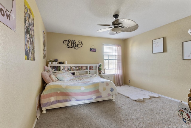 bedroom with a textured wall, carpet, ceiling fan, and a textured ceiling