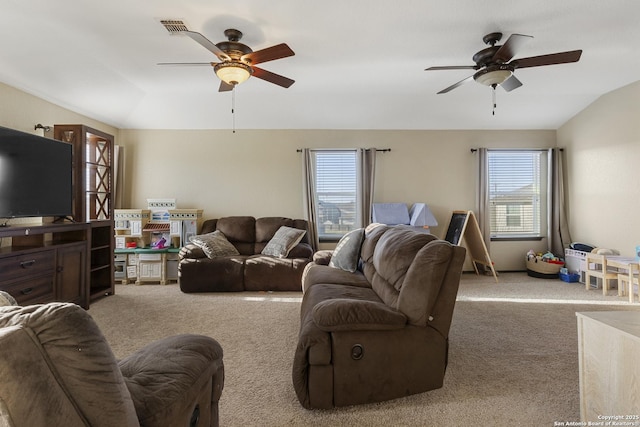 living room with carpet floors, ceiling fan, visible vents, and lofted ceiling