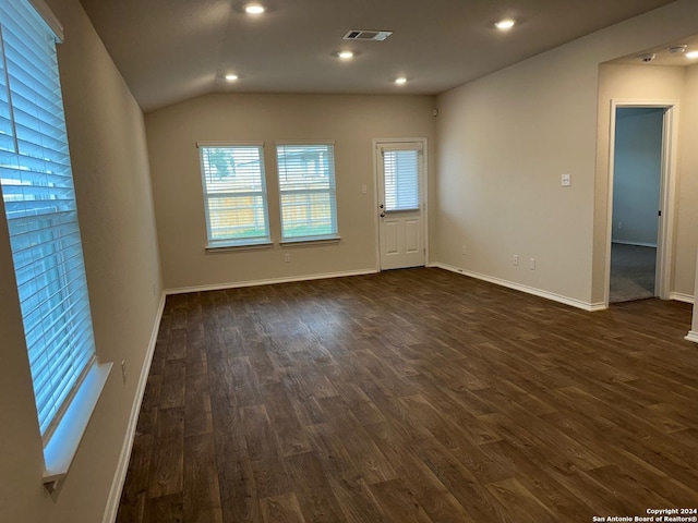 unfurnished room featuring visible vents, baseboards, dark wood-type flooring, vaulted ceiling, and recessed lighting