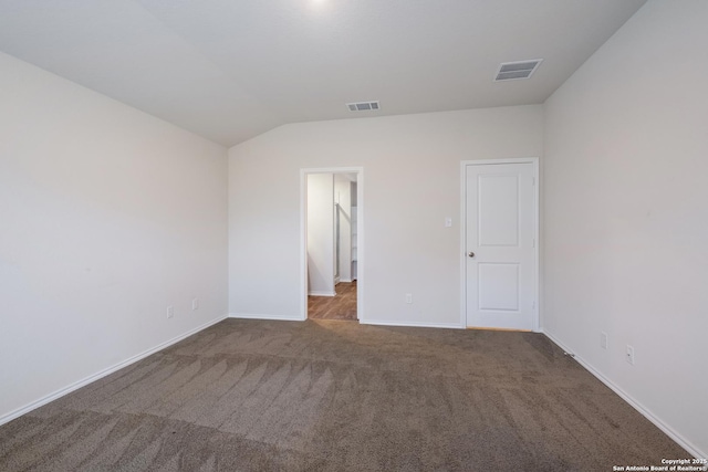 unfurnished bedroom with lofted ceiling, carpet, visible vents, and baseboards