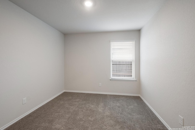 empty room with carpet floors and baseboards