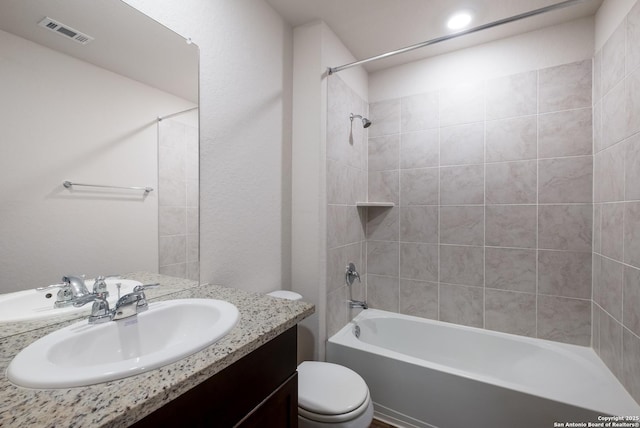 bathroom with toilet, visible vents, tub / shower combination, and vanity