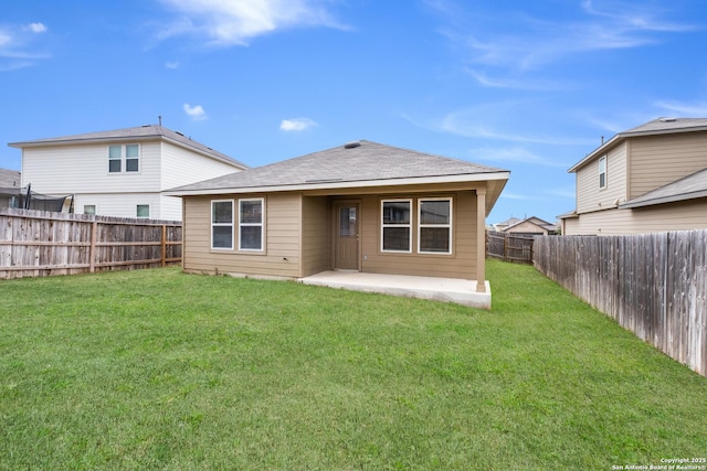 rear view of house with a patio area, a fenced backyard, and a yard