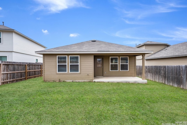 rear view of property featuring a fenced backyard, a shingled roof, a patio, and a yard