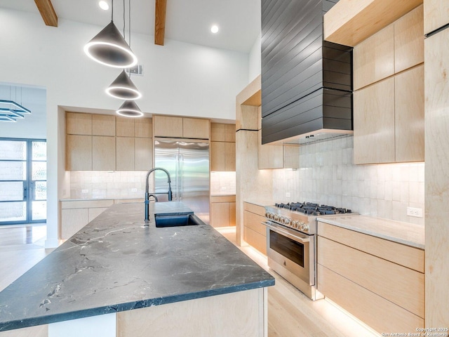 116 Chama Dr, Boerne, TX 78006 - kitchen with dark stone countertops, high quality appliances, light brown cabinets, and modern cabinets