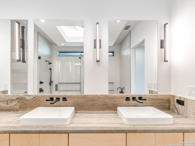 116 Chama Dr, Boerne, TX 78006 - full bathroom with a shower stall, double vanity, visible vents, and a sink