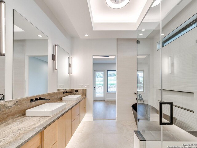 116 Chama Dr, Boerne, TX 78006 - bathroom with tile patterned flooring, double vanity, a sink, and a freestanding tub