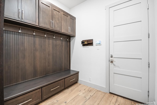 mudroom featuring light wood-style flooring and baseboards