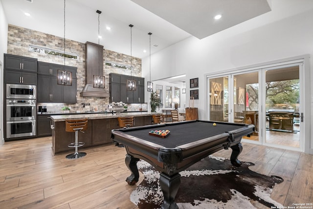 game room featuring recessed lighting, a high ceiling, billiards, french doors, and light wood finished floors