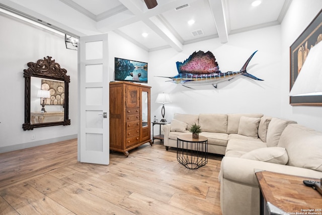 living area featuring light wood-style floors, visible vents, beamed ceiling, and crown molding