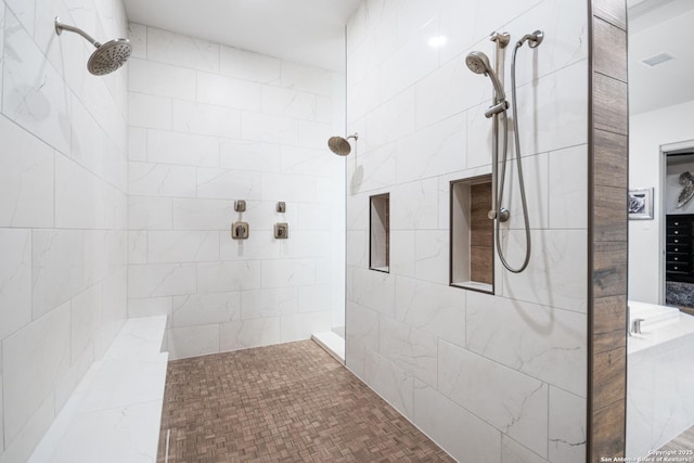 full bath featuring a tile shower