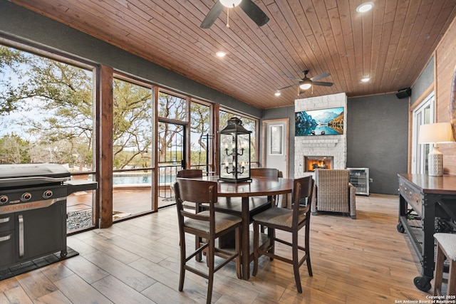 interior space with wooden ceiling, a fireplace, and wood finished floors