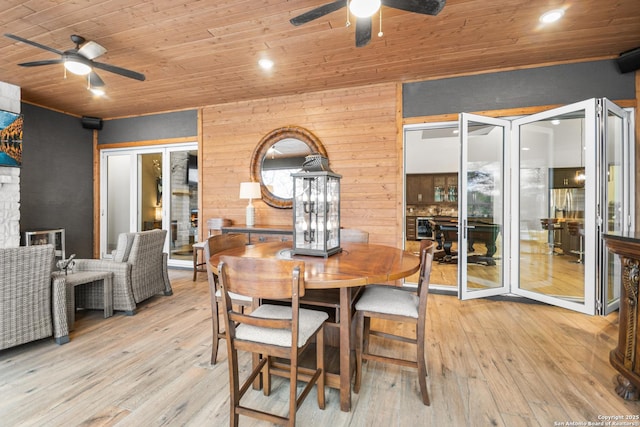 dining area with a ceiling fan, wood ceiling, and light wood-style floors