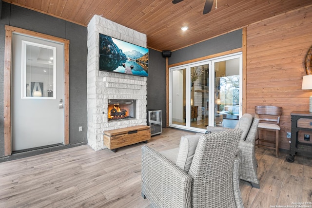 wooden deck with an outdoor stone fireplace