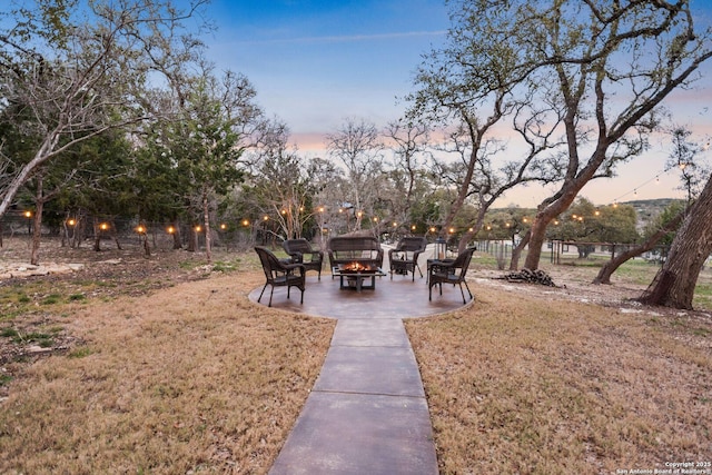 surrounding community with a patio area, an outdoor fire pit, fence, and a lawn