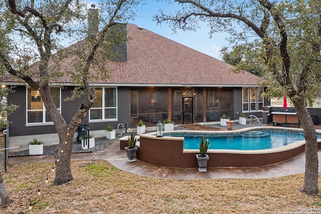 outdoor pool featuring a sunroom