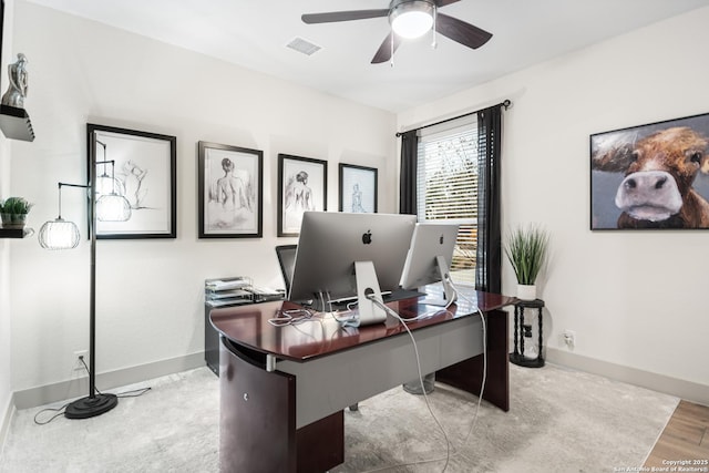 home office featuring ceiling fan, wood finished floors, visible vents, and baseboards