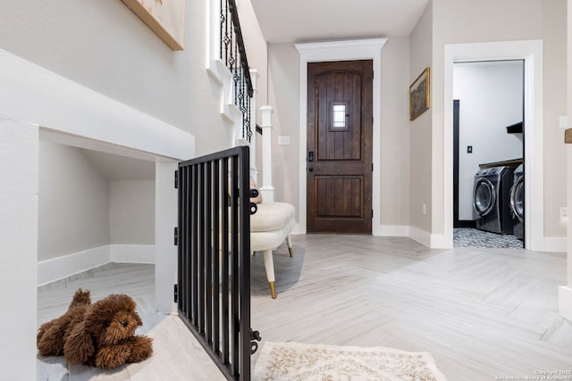 entryway featuring separate washer and dryer and baseboards