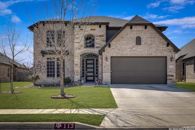 french country inspired facade featuring a garage, concrete driveway, brick siding, and a front lawn