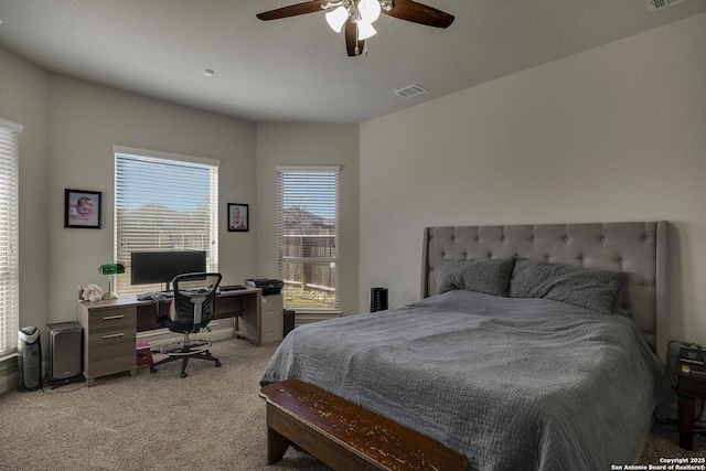 bedroom with ceiling fan, visible vents, and light colored carpet