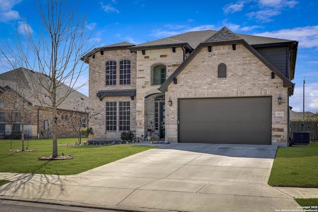 french country style house featuring a garage, concrete driveway, fence, a front yard, and brick siding