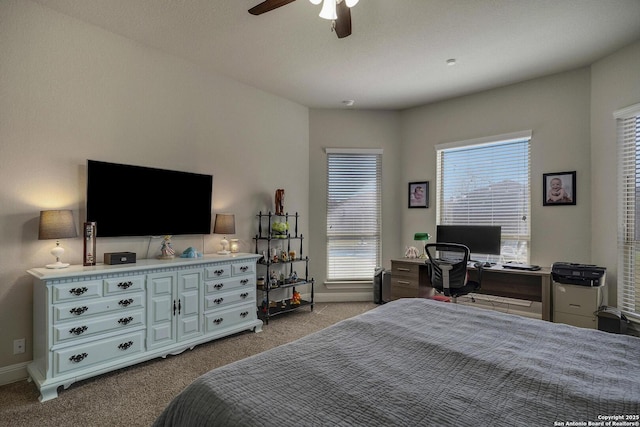 carpeted bedroom with baseboards and a ceiling fan