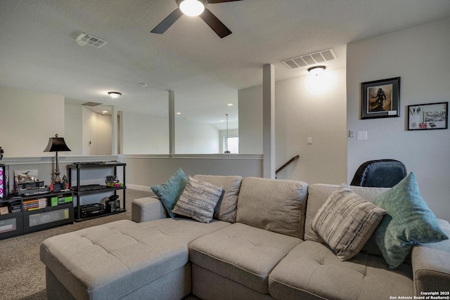 carpeted living room with visible vents and a ceiling fan