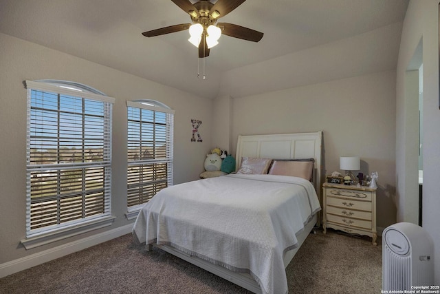 bedroom with carpet, baseboards, vaulted ceiling, and a ceiling fan