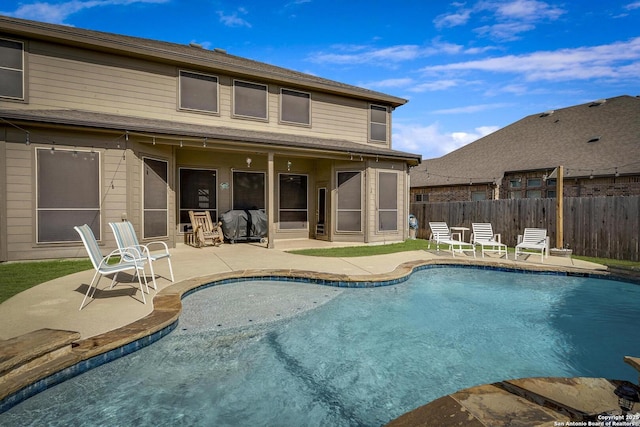 view of pool with a fenced in pool, a patio area, and fence