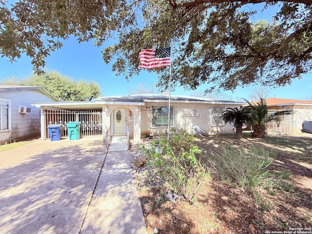 ranch-style house featuring concrete driveway and brick siding