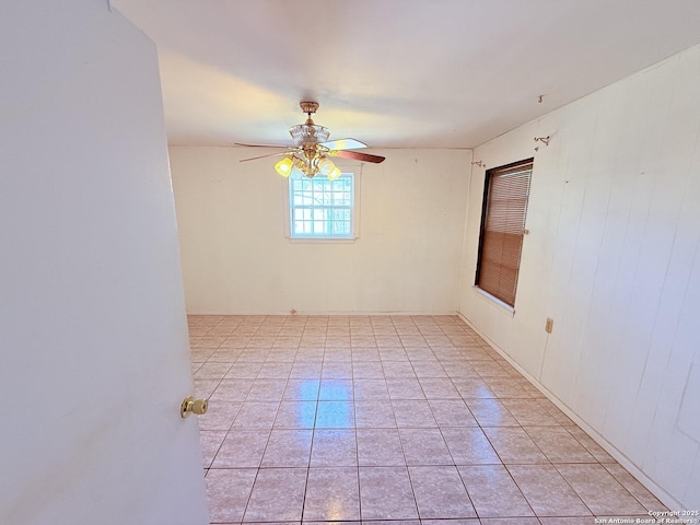 empty room featuring light tile patterned floors and ceiling fan