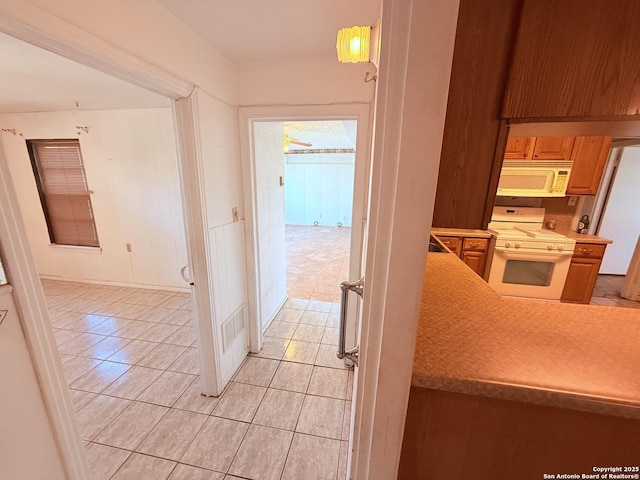 hallway with light tile patterned floors