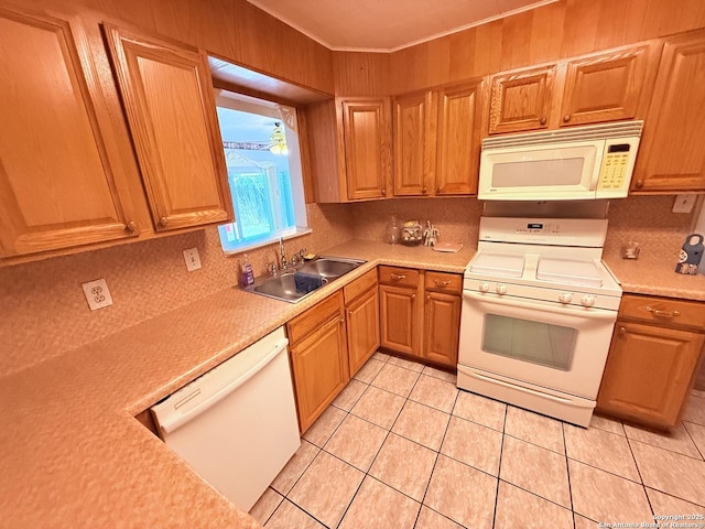 kitchen with light countertops, white appliances, a sink, and decorative backsplash