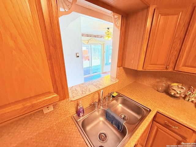 kitchen featuring light countertops and a sink