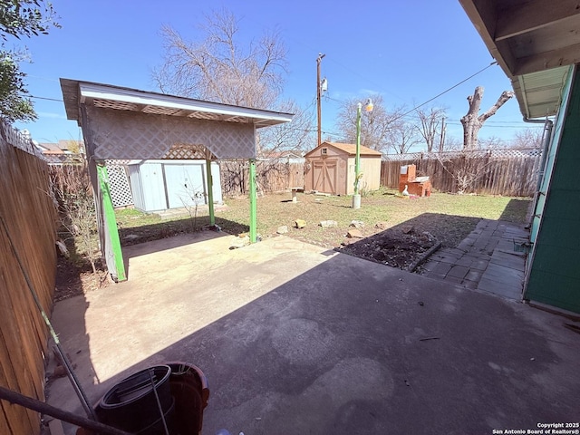 view of patio with a storage shed, a fenced backyard, and an outdoor structure