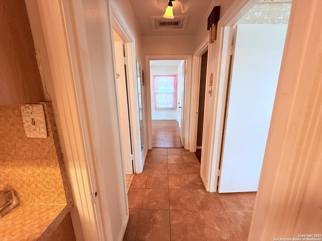 hall with tile patterned flooring and visible vents