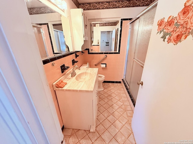 full bathroom featuring vanity, a shower stall, toilet, and tile patterned floors