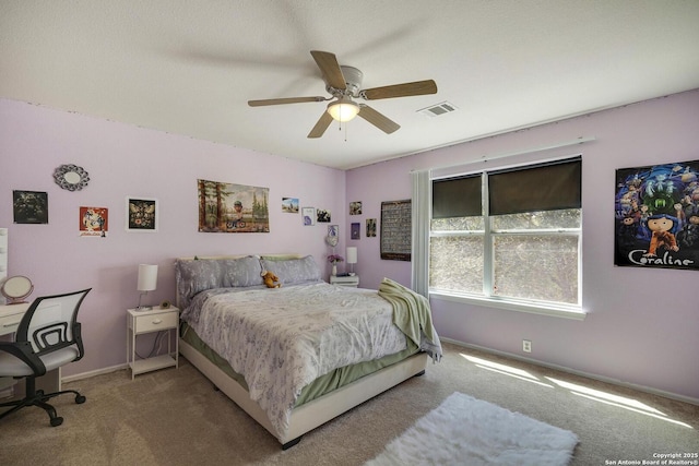 carpeted bedroom with baseboards, visible vents, and ceiling fan