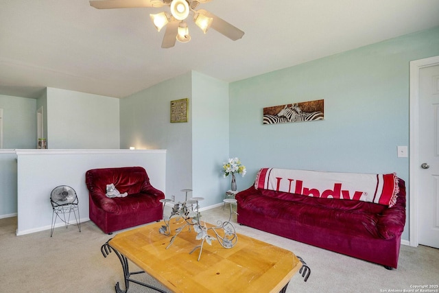 carpeted living room with baseboards and a ceiling fan