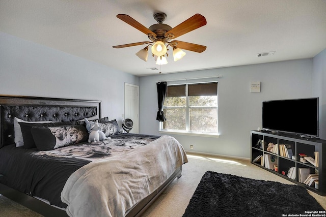 carpeted bedroom featuring visible vents and a ceiling fan