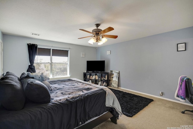 carpeted bedroom with ceiling fan, visible vents, and baseboards